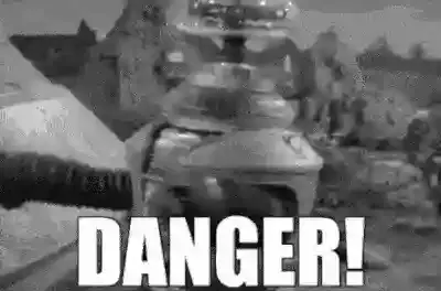 Robot swinging around flinging his arms with the text DANGER! on the frame, gif, grayscale